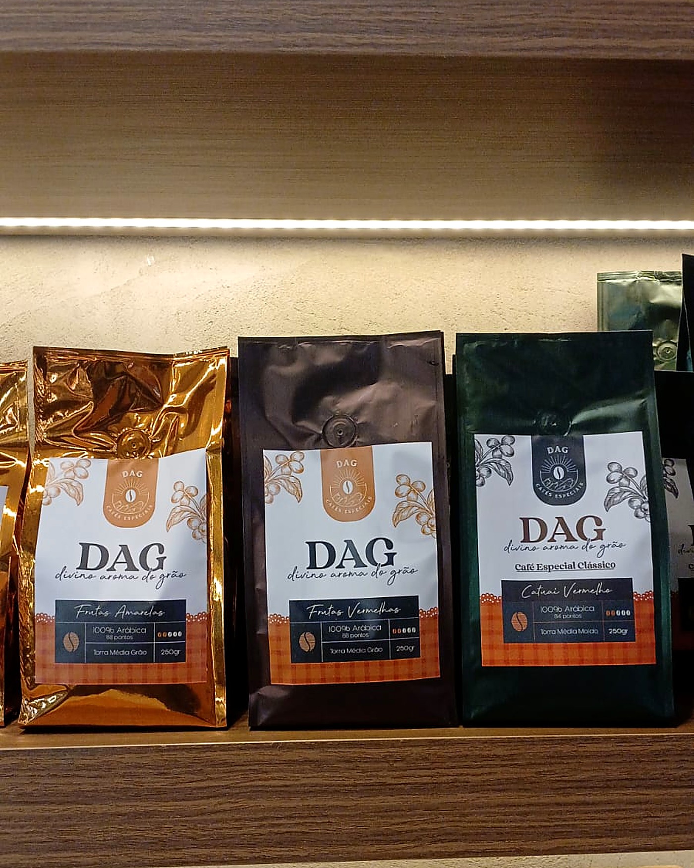 Pacotes de cafés especiais artesanais expostos em prateleira iluminada