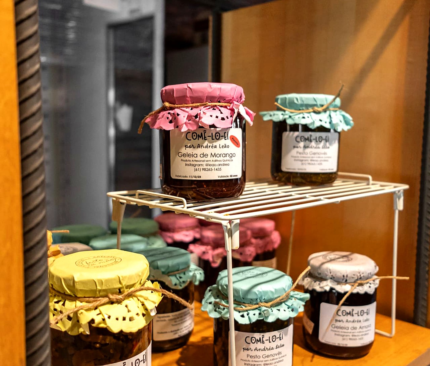 Geleias, pestos e caponatas artesanais em potes de vidro nas prateleiras da Mercearia